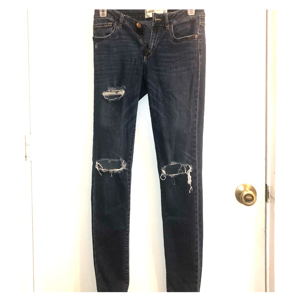 Garage ripped blue jeans